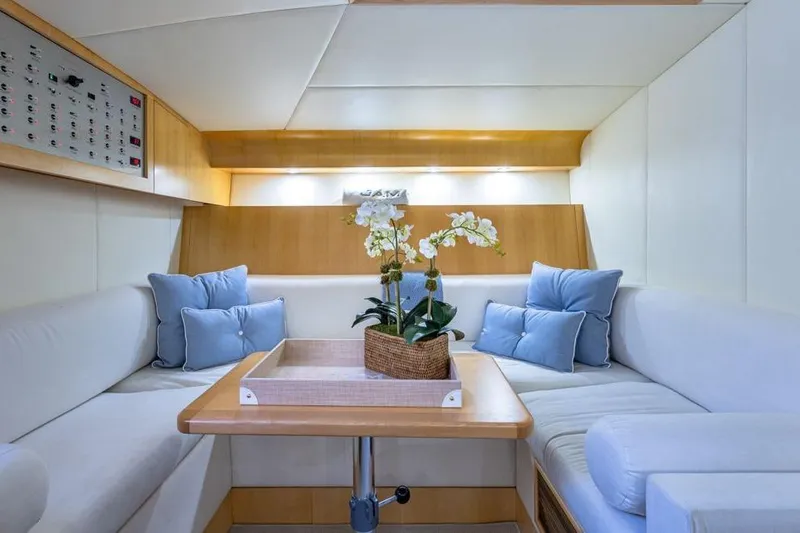 Jam Yacht Photos Pics Luxurious interior of 2013 Magnum 51 Bestia yacht with elegant seating and floral centerpiece.