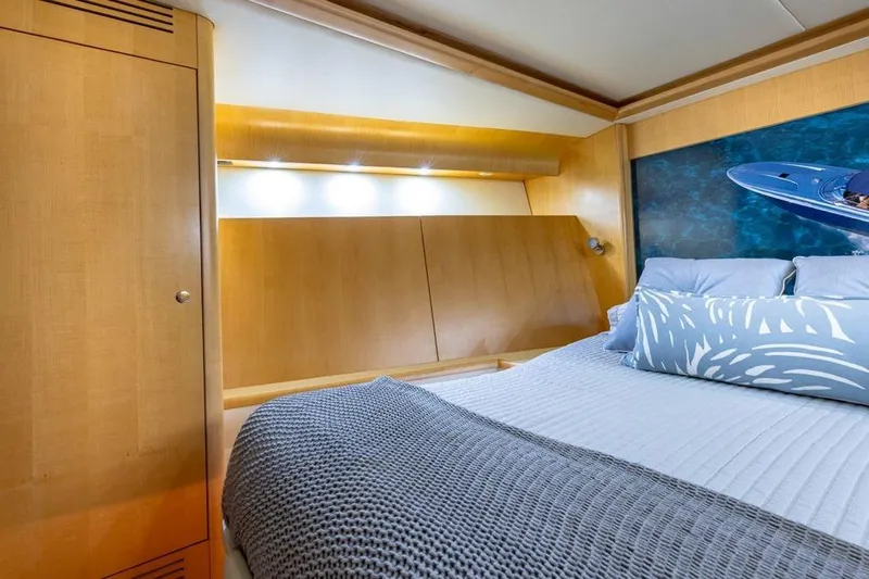 Jam Yacht Photos Pics Luxurious cabin interior of 2013 Magnum 51 Bestia yacht with modern wood paneling.
