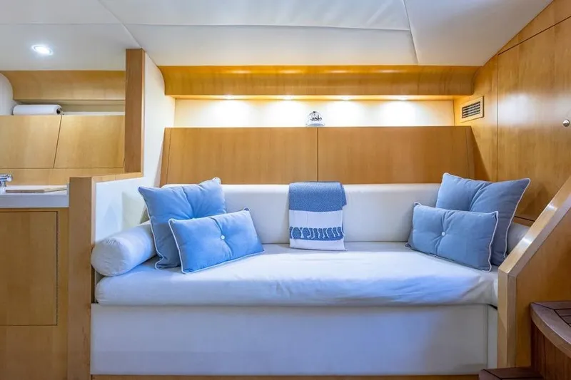 Jam Yacht Photos Pics Luxurious interior of 2013 Magnum 51 Bestia yacht with cozy seating and blue cushions.