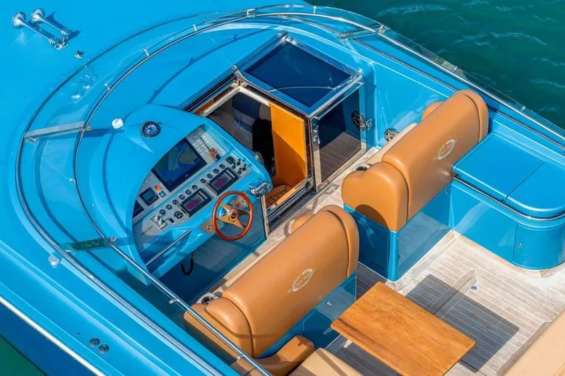 Jam Yacht Photos Pics Luxurious 2013 Magnum 51 Bestia yacht interior with blue and tan design, featuring a sleek control panel.