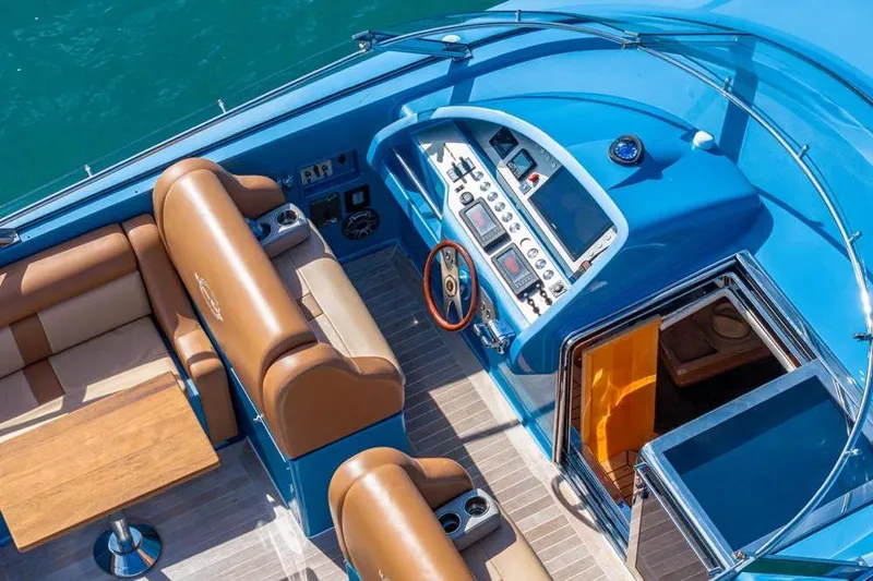 Jam Yacht Photos Pics Luxurious 2013 Magnum 51 Bestia yacht cockpit with blue dashboard and leather seating.