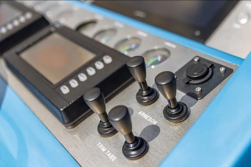 Jam Yacht Photos Pics Control panel of 2013 Magnum 51 Bestia with levers and display screen.