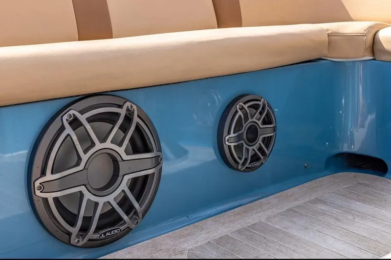 Jam Yacht Photos Pics Speakers on a 2013 Magnum 51 Bestia boat, featuring beige seating and blue paneling.