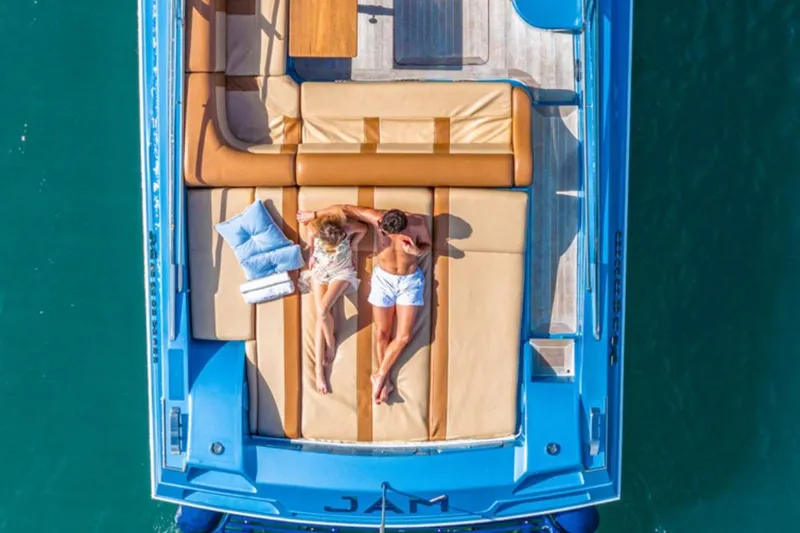 Jam Yacht Photos Pics Aerial view of a 2013 Magnum 51 Bestia yacht with two people sunbathing.