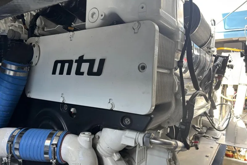 Jam Yacht Photos Pics Engine compartment of 2013 Magnum 51 Bestia with MTU branding and blue hoses.