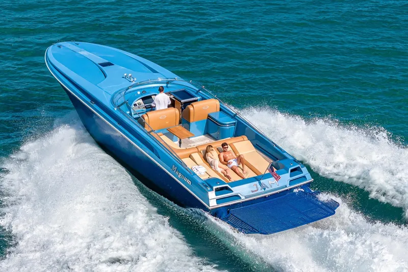 Jam Yacht Photos Pics 2013 MAGNUM MARINE 51 Bestia speedboat cruising on open water with passengers onboard.