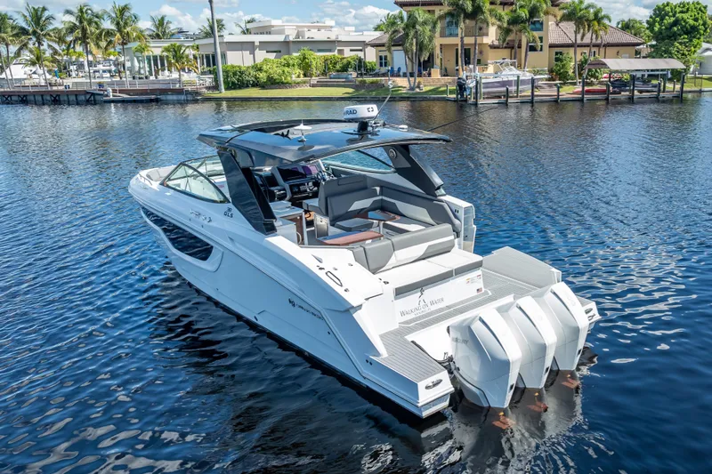  Yacht Photos Pics 2022 Cruisers Yachts 38 GLS OB on serene water, showcasing sleek design and powerful outboard engines.