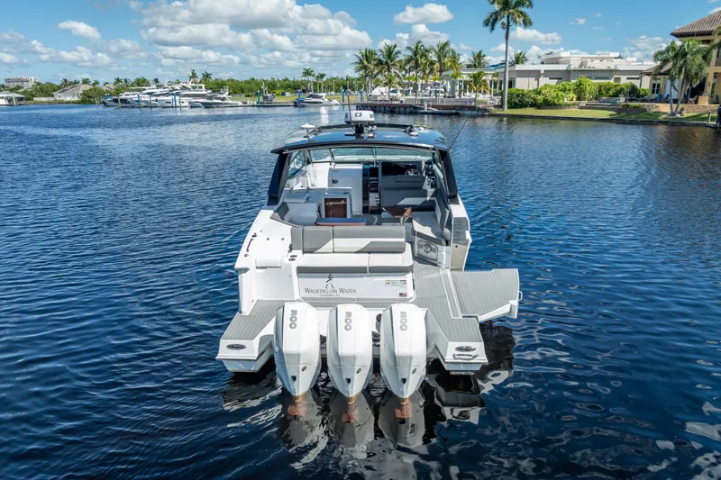  Yacht Photos Pics 2022 Cruisers Yachts 38 GLS OB on serene water, showcasing sleek design and powerful outboard engines.