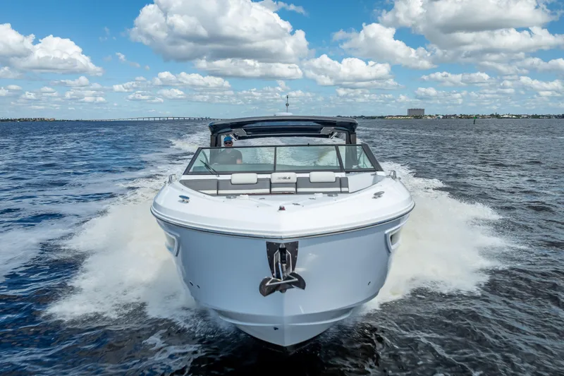  Yacht Photos Pics 2022 Cruisers Yachts 38 GLS OB speeding on open water under a cloudy sky.