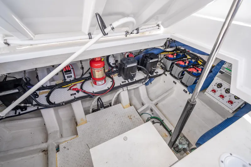  Yacht Photos Pics Engine compartment of 2022 Cruisers Yachts 38 GLS OB, featuring batteries and fire extinguisher.