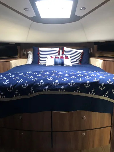  Yacht Photos Pics Luxurious cabin interior of 2007 Fairline Squadron 68 yacht with nautical-themed bedding.