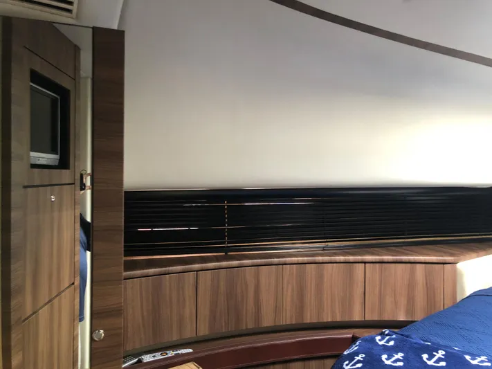  Yacht Photos Pics Luxurious interior of 2007 Fairline Squadron 68 yacht with wood paneling and nautical-themed bedding.