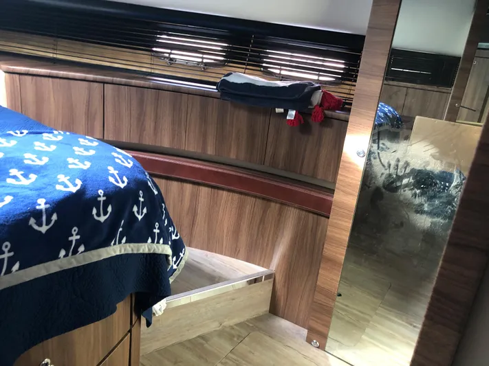  Yacht Photos Pics Interior cabin of 2007 Fairline Squadron 68 yacht with nautical-themed bedding.