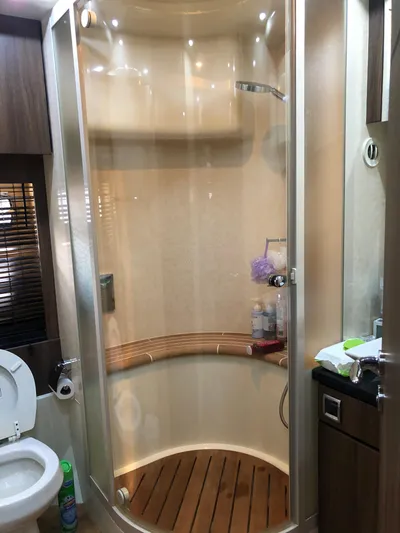  Yacht Photos Pics Luxury yacht bathroom with modern shower, wooden floor, and elegant fixtures on Fairline Squadron 68, 2007.