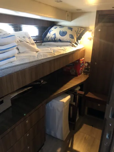  Yacht Photos Pics Cozy cabin interior of 2007 Fairline Squadron 68 yacht with wooden furnishings and bedding.