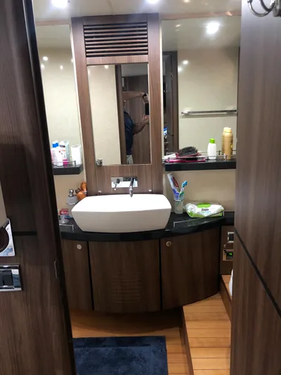  Yacht Photos Pics Luxurious bathroom in 2007 Fairline Squadron 68 yacht with modern sink and wooden cabinetry.