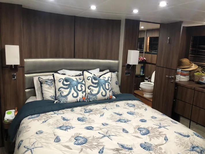  Yacht Photos Pics Luxurious bedroom in 2007 Fairline Squadron 68 yacht with nautical-themed decor.