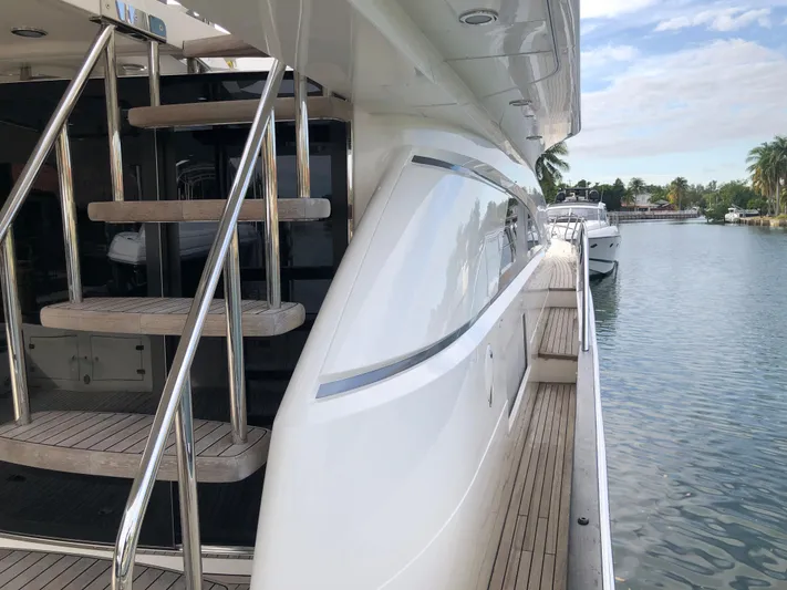  Yacht Photos Pics 2007 Fairline Squadron 68 yacht with sleek design and wooden deck, docked by calm waters.