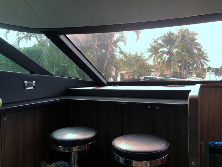  Yacht Photos Pics Interior view of 2007 Fairline Squadron 68 yacht with bar stools and large windows.