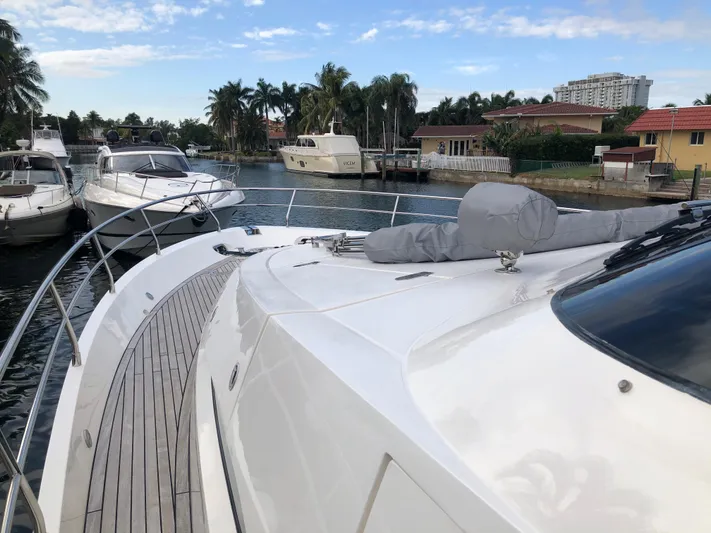  Yacht Photos Pics 2007 Fairline Squadron 68 yacht docked in a scenic marina with palm trees.
