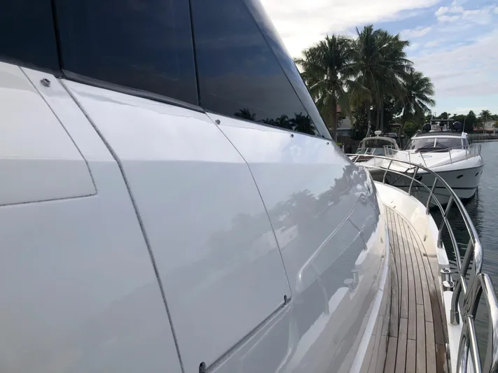  Yacht Photos Pics 2007 Fairline Squadron 68 yacht with sleek design, docked near palm trees.