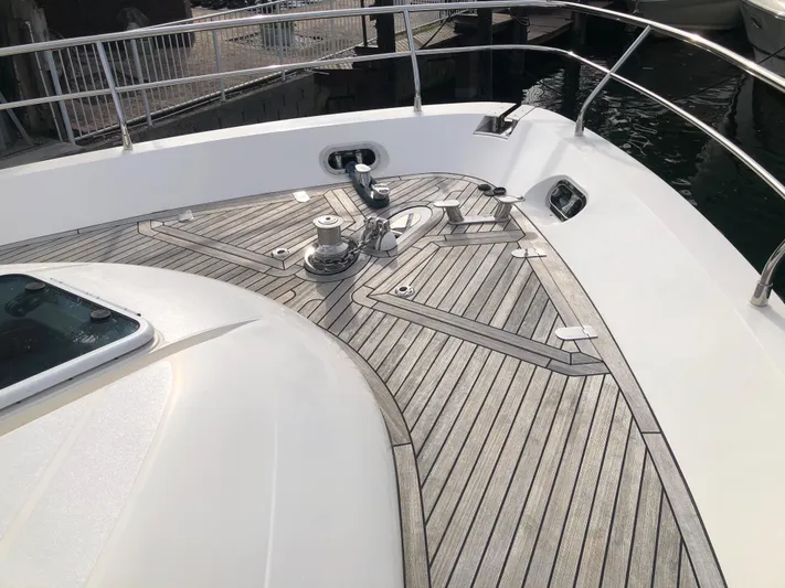  Yacht Photos Pics 2007 Fairline Squadron 68 yacht deck with sleek wood finish and railing.