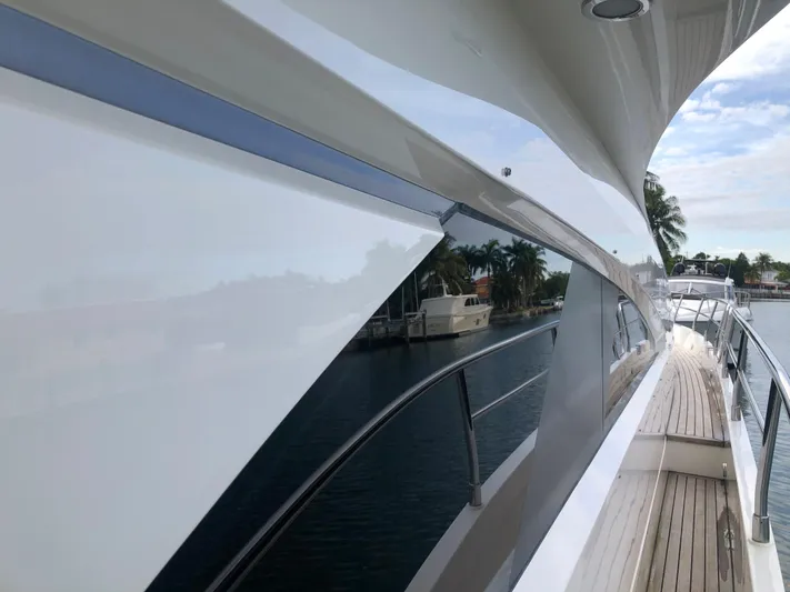  Yacht Photos Pics 2007 Fairline Squadron 68 yacht, sleek design, docked by palm trees and calm water.