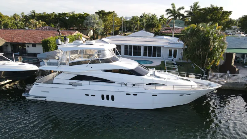  Yacht Photos Pics Luxury 2007 Fairline Squadron 68 yacht docked by waterfront home, surrounded by lush greenery.