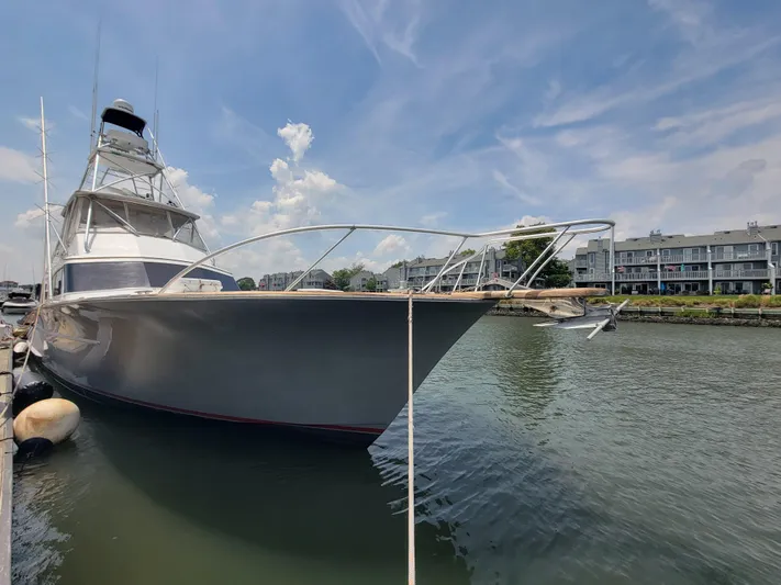  Yacht Photos Pics 1998 Buddy Davis 65 Carolina Custom yacht docked in a marina under a clear sky.