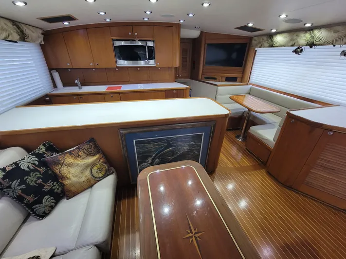  Yacht Photos Pics Luxurious interior of 1998 Buddy Davis 65 Carolina Custom yacht with wood finishes and seating area.