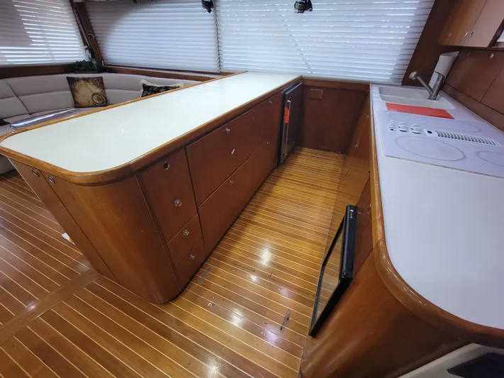  Yacht Photos Pics Interior of 1998 Buddy Davis 65 Carolina Custom yacht with wooden flooring and modern kitchen.