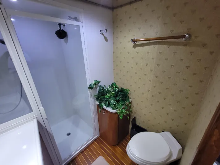  Yacht Photos Pics Bathroom interior of 1998 Buddy Davis 65 Carolina Custom yacht, featuring shower and toilet.