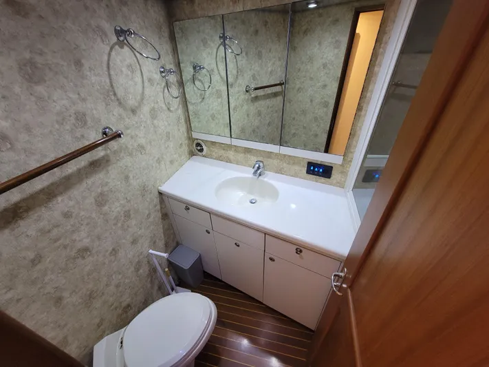  Yacht Photos Pics Bathroom interior of 1998 Buddy Davis 65 Carolina Custom yacht, featuring sink and toilet.