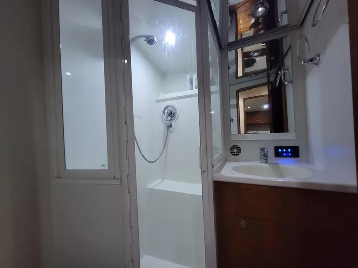  Yacht Photos Pics Bathroom interior of 1998 Buddy Davis 65 Carolina Custom yacht, featuring shower and sink.