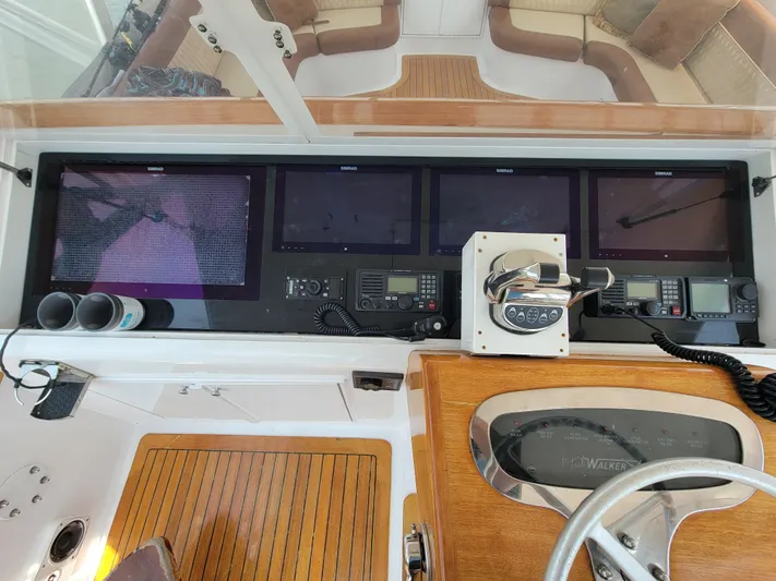  Yacht Photos Pics Control panel of 1998 Buddy Davis 65 Carolina Custom yacht with navigation screens and steering wheel.