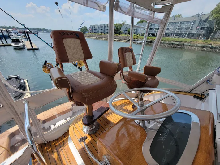  Yacht Photos Pics 1998 Buddy Davis 65 Carolina Custom yacht helm with leather seats and fishing rods.