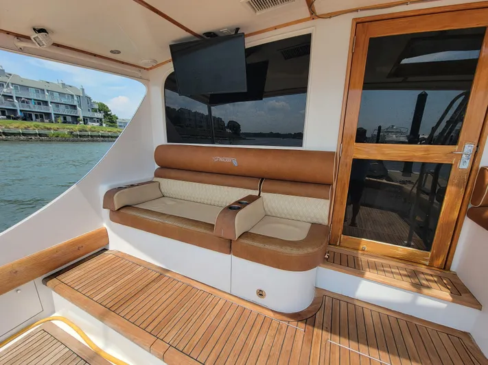  Yacht Photos Pics 1998 Buddy Davis 65 Carolina Custom yacht with teak deck and cushioned seating area.