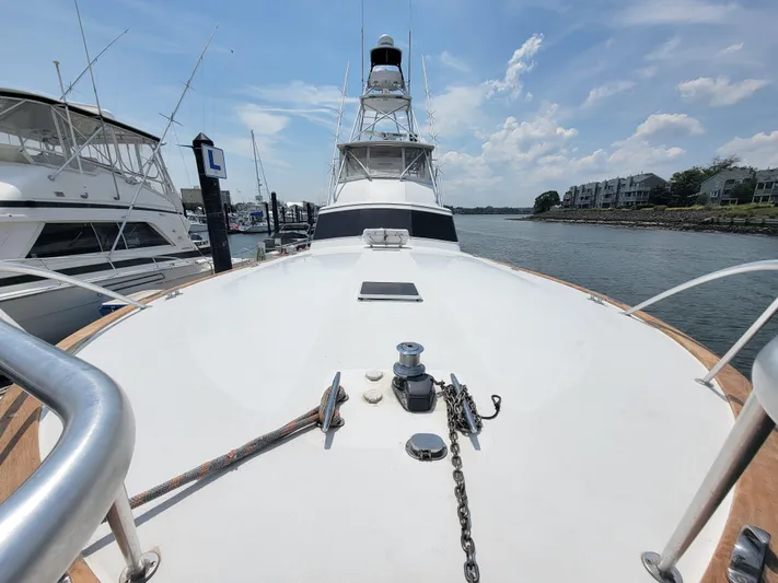  Yacht Photos Pics 1998 Buddy Davis 65 Carolina Custom yacht docked, showcasing spacious deck and clear sky.