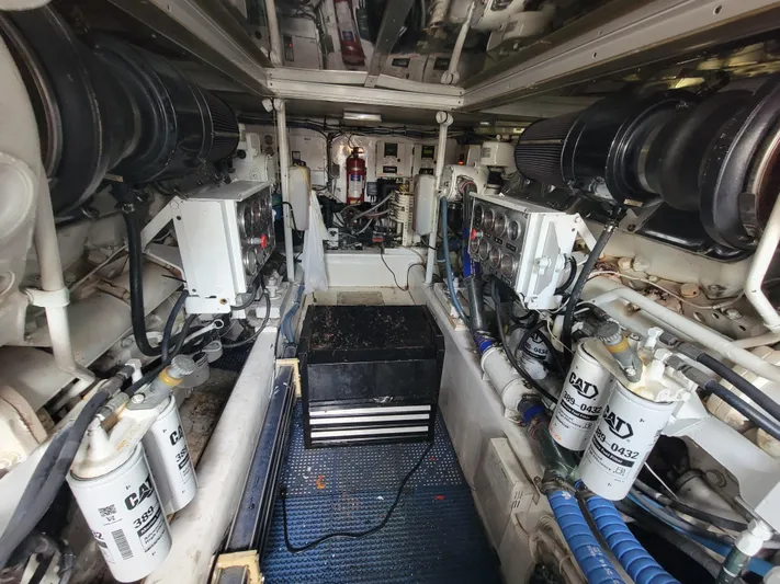  Yacht Photos Pics Engine room of 1998 Buddy Davis 65 Carolina Custom yacht, showcasing mechanical components.