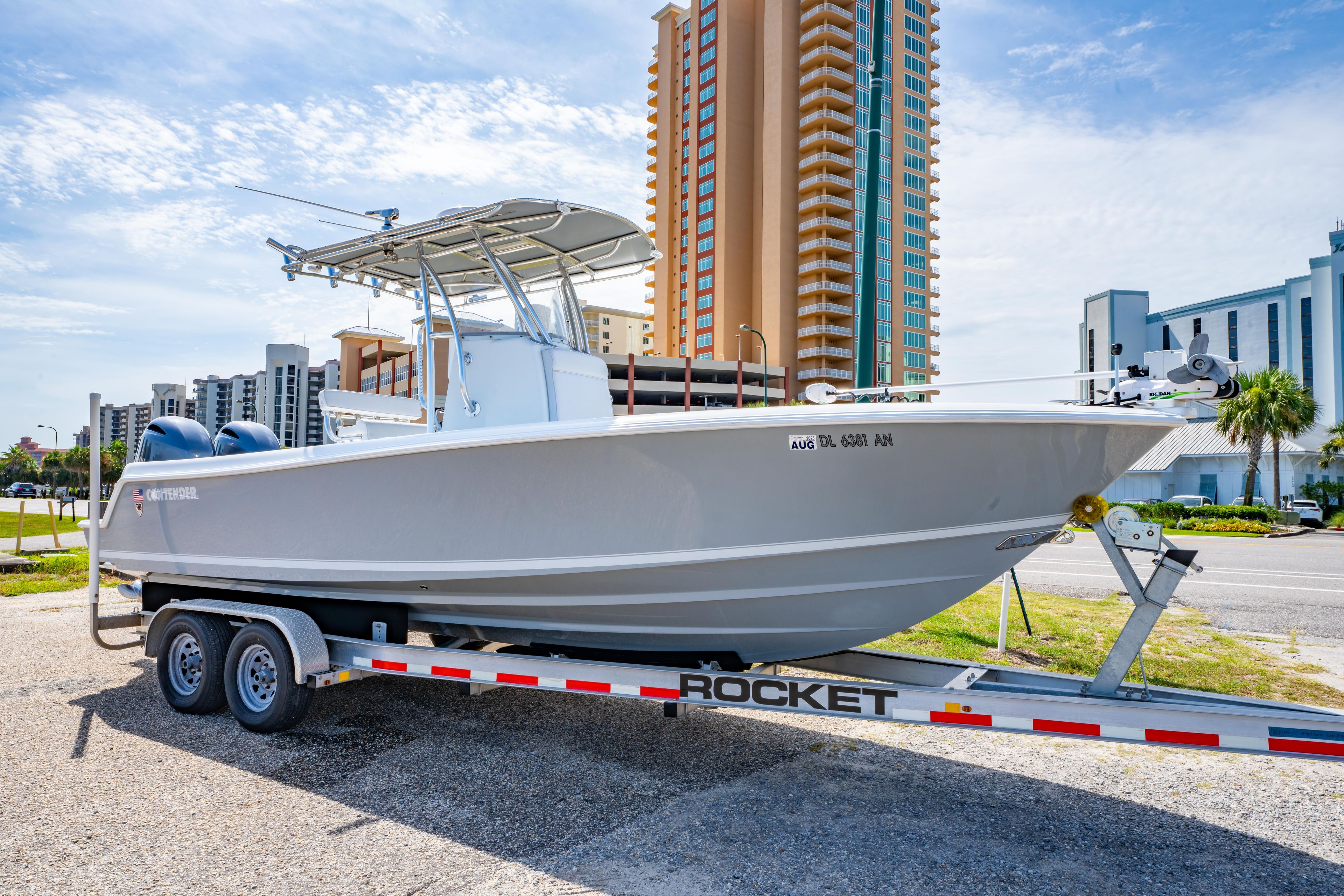 2022 Contender 25T boat on trailer, urban background, clear sky.