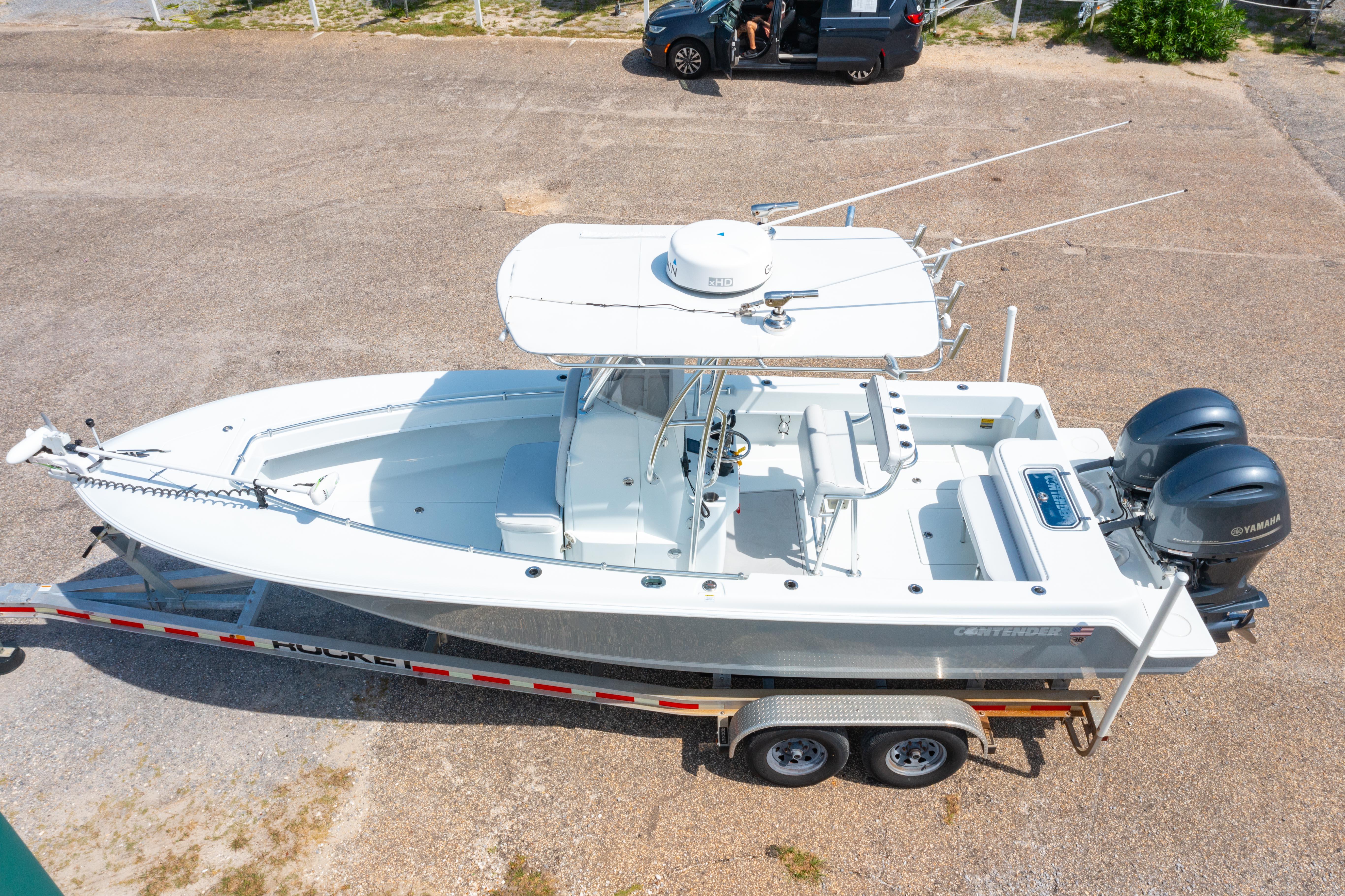 2022 Contender 25T boat on trailer with dual Yamaha engines, aerial view.