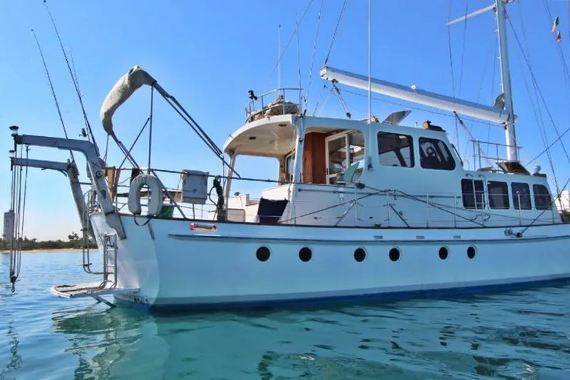 Yacht Photos Pics Custom Centre Cockpit Pilot House Steel Cutter Motorsailer, 70 ft, 1991, on calm water.