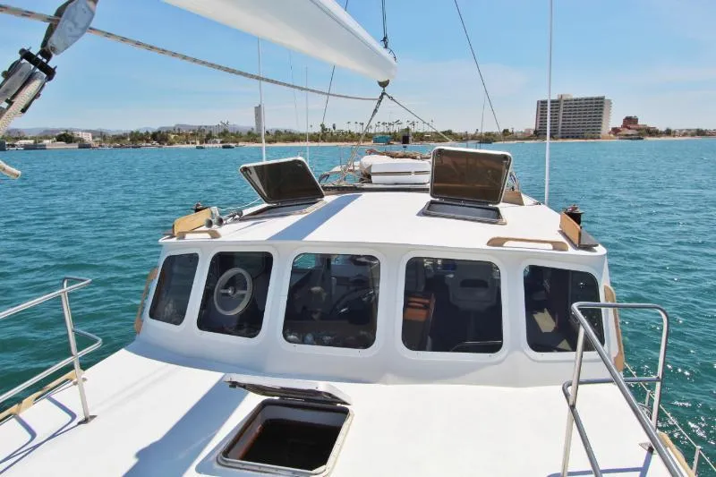  Yacht Photos Pics Centre cockpit pilot house steel cutter motorsailer on calm blue water, 1991 model.