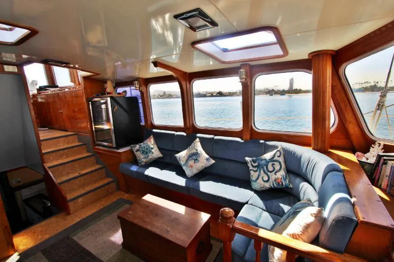  Yacht Photos Pics Luxurious interior of a 1991 Custom Centre Cockpit Pilot House Motorsailer with scenic ocean views.