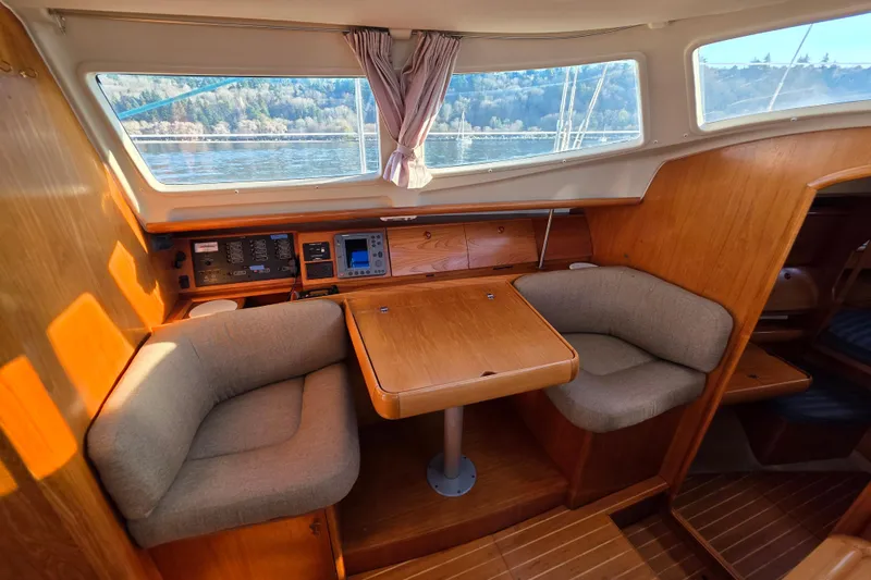 Hayabusa Yacht Photos Pics Interior of 1999 Jeanneau Sun Odyssey 40 DS sailboat with cozy seating and navigation equipment.