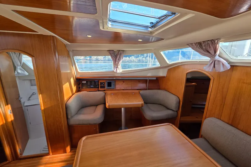 Hayabusa Yacht Photos Pics Interior of 1999 Jeanneau Sun Odyssey 40 DS sailboat with wood finish and seating area.