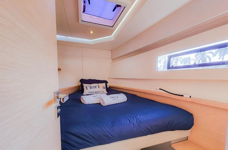 Floripa Yacht Photos Pics Cozy cabin interior of 2017 Fountaine Pajot MY 37 yacht with blue bedding.
