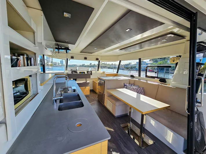 Floripa Yacht Photos Pics Interior of 2017 Fountaine Pajot MY 37 yacht with modern kitchen and dining area.