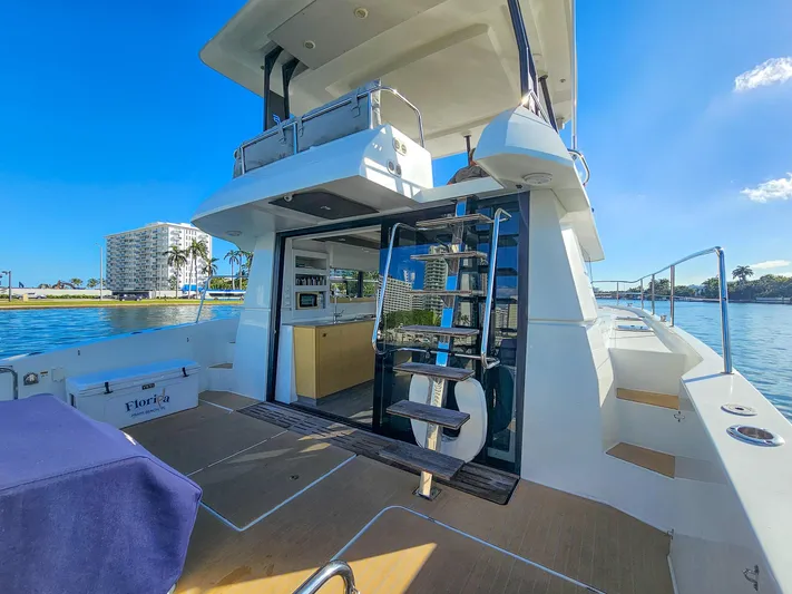 Floripa Yacht Photos Pics 2017 Fountaine Pajot MY 37 yacht with modern design, docked by waterfront buildings.