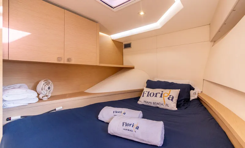Floripa Yacht Photos Pics Cozy cabin interior of 2017 Fountaine Pajot MY 37 yacht with Florida-themed bedding.